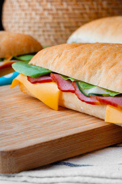 istock Sandwich with ham and cheese on wooden board 1436031182