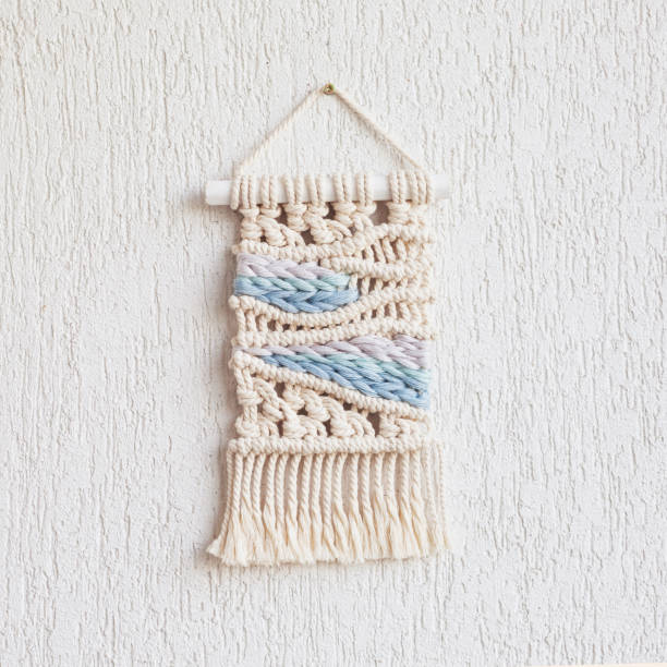 istock Handmade macrame. 100% cotton wall hanging decoration. Maritime theme.  Macrame braiding and cotton threads.  Female hobby.  ECO friendly modern knitting DIY natural decoration concept in the interior 1436031218