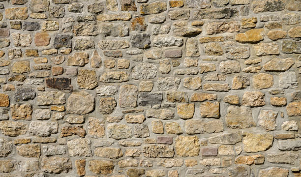 istock Light brown antique stone wall as background. 1436033420