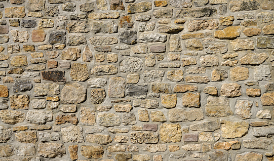 Light brown antique stone wall as background.