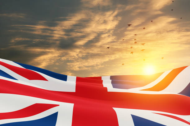 National flags of United Kingdom with flying birds on sunset sky background. National flags of United Kingdom with flying birds on sunset sky background. Background with place for your text. 3d rendering. 1926 stock pictures, royalty-free photos & images