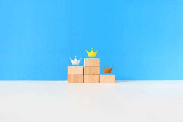 istock Gold, silver and bronze crowns on the podium. 1436035372