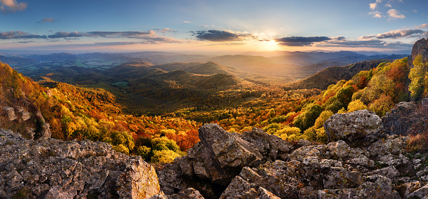 Sunset in a rocky forest landscape with autumn nature. Stiavnicke hill, Sitno, Slovakia.