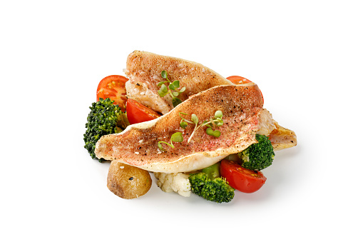 Baked Fillet of fish perch with broccoli, cauliflower, tomatoes, potatoes isolated on a white background, clipping path, cut out.