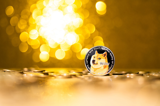 Fujian, China - December 28, 2021: Dogecoin cryptocurrency on shiny background.