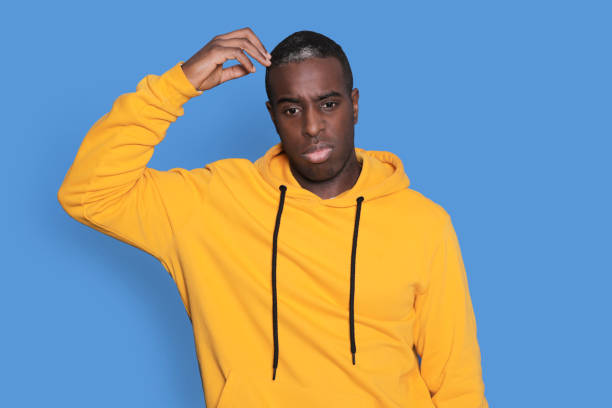istock Black man pointing his finger above him 1436038824