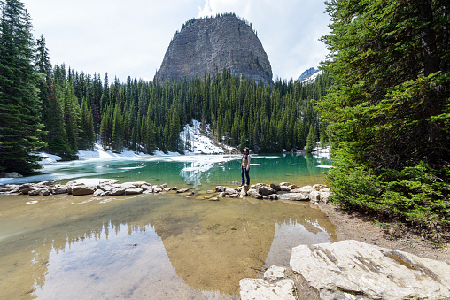 A tourist woman enjoying the tranquil scene of Mirror lake, Banff National Park