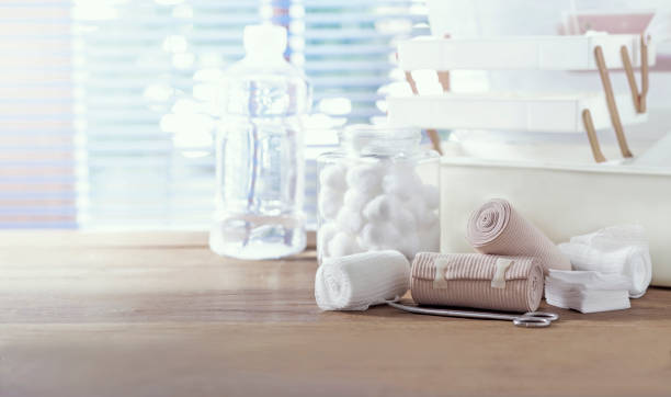 Bandage, home first aid kit on table, blurred background stock photo