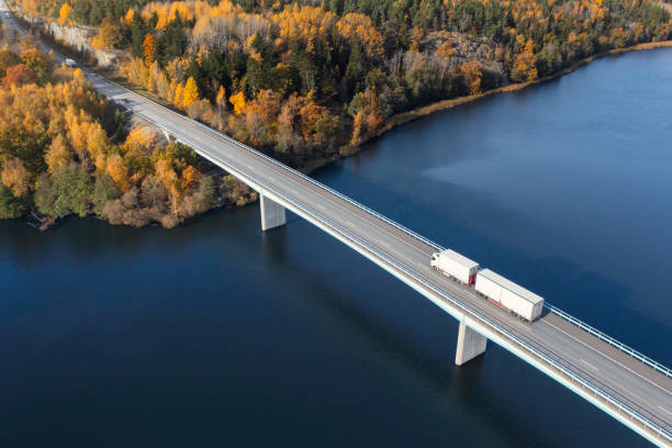 istock Truck crossing a highway bridge in autumn 1436040497