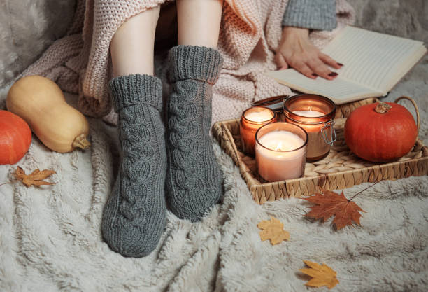 istock Girl covered with a blanket in knitted socks. 1436040498