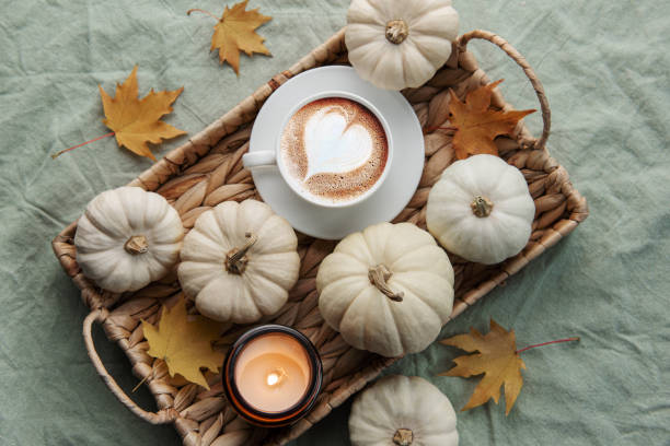 istock White pumpkins, coffee and autumn leaves on a wicker tray. 1436040907