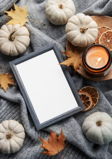 istock Autumn composition. Photo frame, pumpkins, dried leaves 1436040914