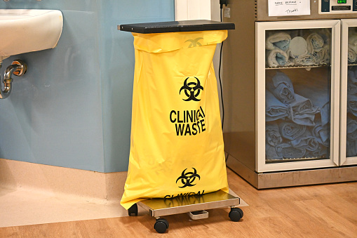 Yellow clinical waste bin in a hospital