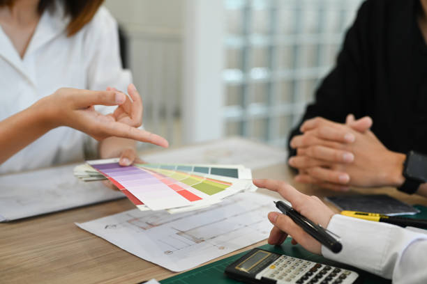 istock Interior designer team selecting colors for building and planning construction project together at office. 1436042144