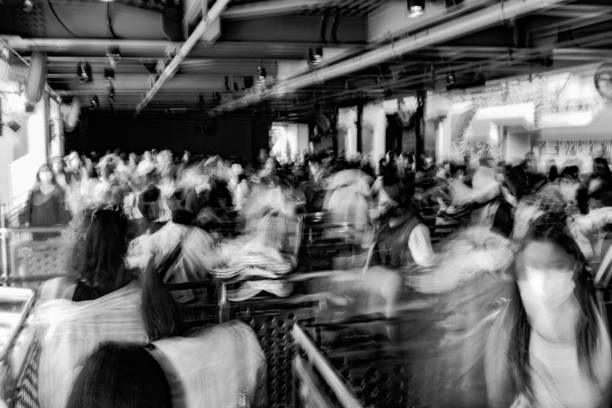 Crowd of people queuing, motion blur