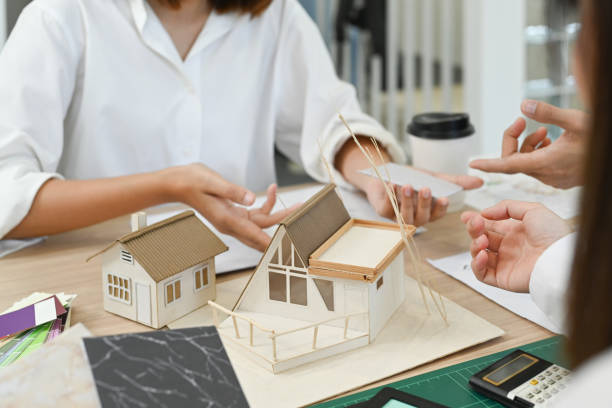 istock Professional team of engineers or architects, brainstorming together over joint building project during meeting in modern office. 1436042193
