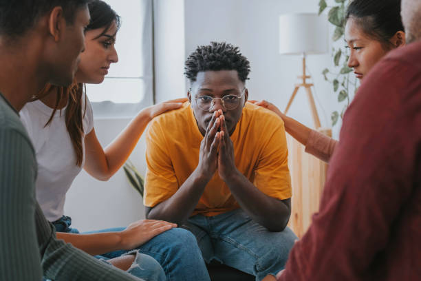 Sad African American guy get psychological support of counselor therapist - Social issue and racism concept Sad African American guy get psychological support of counselor therapist - Social issue and racism concept substance abuse stock pictures, royalty-free photos & images