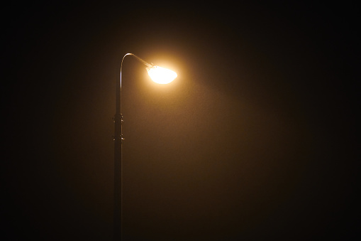 Lamppost in a mountain village on a snowy winter night.