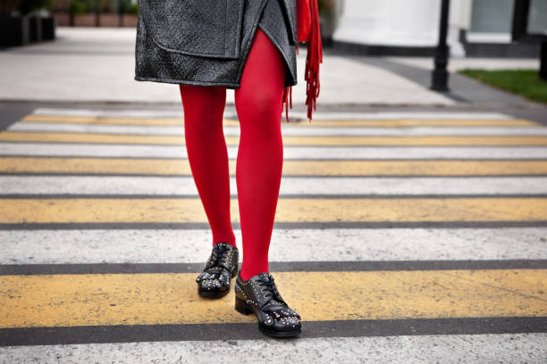 Woman legs in red color tights, black leather shoes with rivets and skirt stand on crosswalk. Fashion details for stylish extravagant women Woman legs in red color tights, black leather shoes with rivets and skirt stand on crosswalk. Fashion details for stylish extravagant women pantyhose stock pictures, royalty-free photos & images