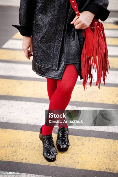 Woman Legs In Red Color Tights Black Leather Shoes With Rivets And