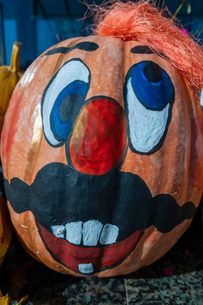 istock Happy ukrainian man face on painted pumpkin, close up 1436045417