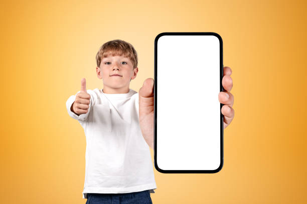 istock Boy wearing casual wear holding smartphone case with copy space 1436047597