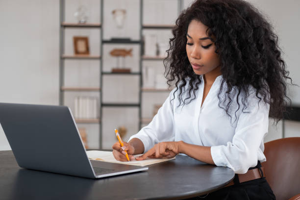 istock Black businesswoman take note, working in modern office room 1436047609