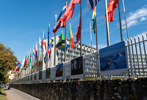 Paris, France - October 07 2022: Flags fluttering in the wind in front of the UNESCO (United Nations Educational, Scientific and Cultural Organization) headquarters at 7 place de Fontenoy in Paris.