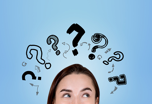 Young woman eyes with curious look, searching for answers. Doodle question marks on blue background. Concept of career development and education