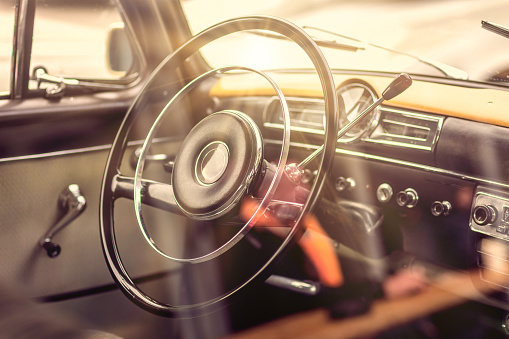 Image of a classic german car interior with focus on the steering wheel