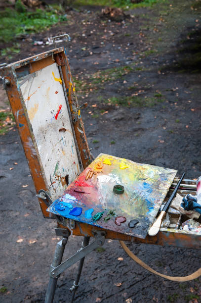 The artist's palette with brushes in a box is on the street, ready to work. Selective focus stock photo