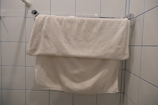 Clean white towel hanging in the bathroom