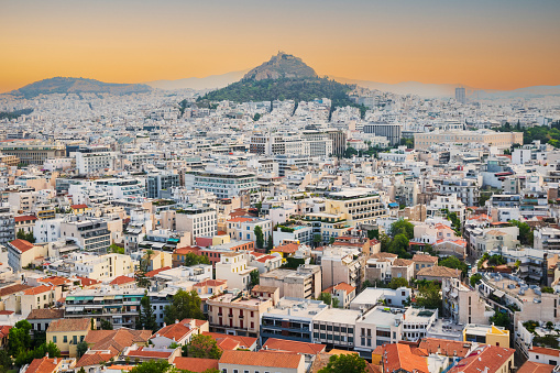View of dense cityscape of Athens in Greece with Mount Lycabettus during sunset