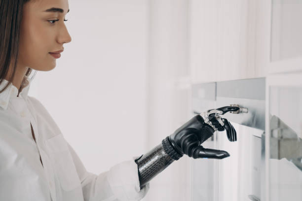 istock Modern disabled girl with bionic prosthetic arm turns oven on, cooking in kitchen at home, close up 1436056274