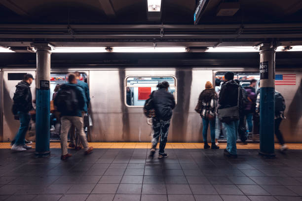 Crowd of people in a NYC subway station waiting for the train stock photo