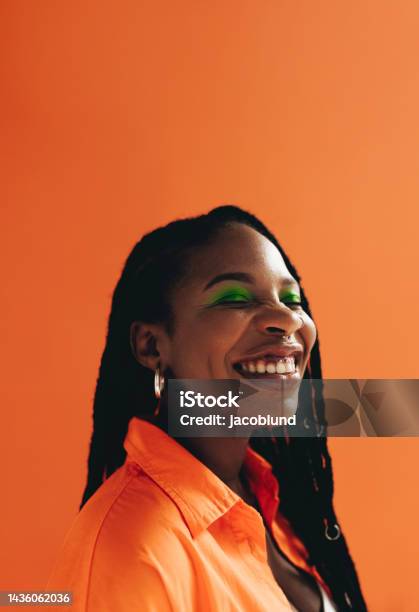 Cheerful African Woman With Makeup And Face Piercings Smiling In A Studio Stock Photo - Download Image Now