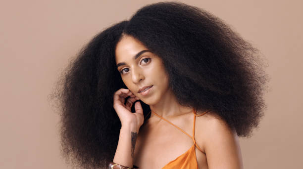 black woman afro, beauty and hair for salon fashion style against a mockup studio background. portrait of a beautiful happy african american female model with curly, frizzy or stylish hairdo - frizzy human hair fashion model african ethnicity imagens e fotografias de stock