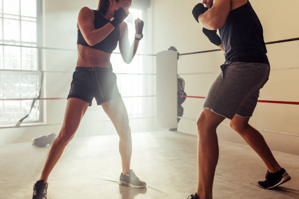 istock Two young fighters facing each other in a boxing ring 1436062513