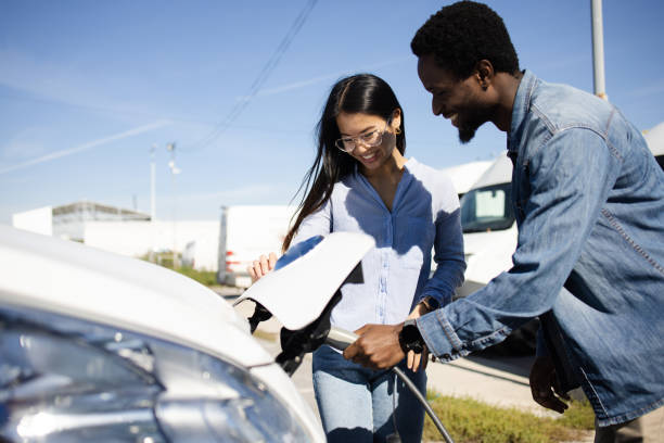 istock Young couple on vacation charging their electric camper 1436063804