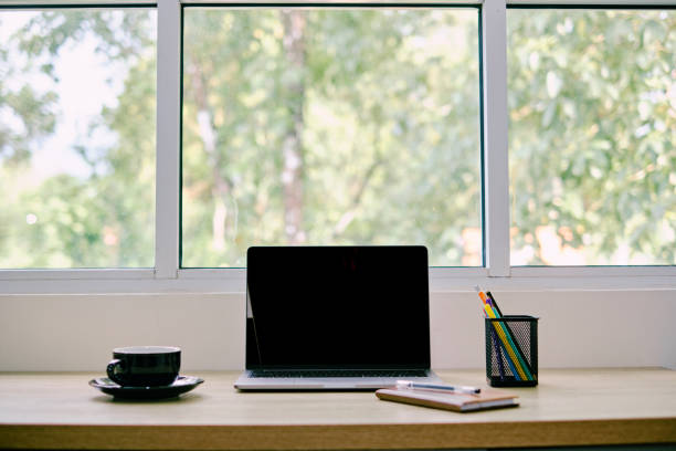istock White office desk with laptop computer, coffee cup, notebook and stationery. 1436064777