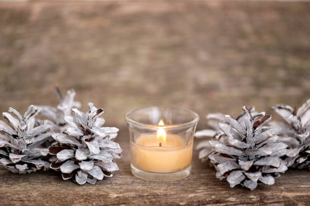 istock Christmas decorations candle and pine cones on a wooden background. 1436064944