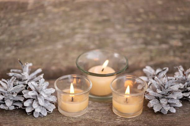 istock Christmas candle decorations and pine cones on a wooden background. copy space 1436065023