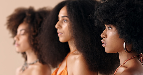 Side profile, model and natural beauty of black women standing with afro hair. Stunning, beautiful and pretty people from Madrid with a big and trendy hairstyle fashion and a serious face expression