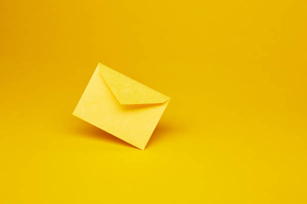 istock Yellow office envelope for greeting or invitation on the yellow background 1436067071