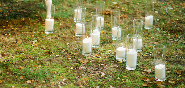 Candles, decor, wedding ceremony in the forest in nature.