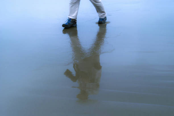 istock person walking on sandy beach 1436068699