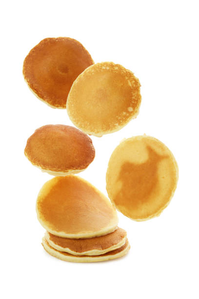 istock Tasty falling pancakes isolated on white background 1436069608