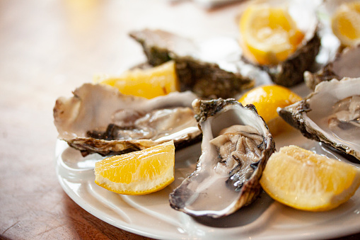 Lemon and oysters on ice bed