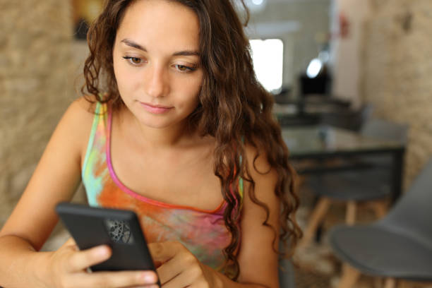 istock Serious woman using smart phone in a restaurant 1436074555