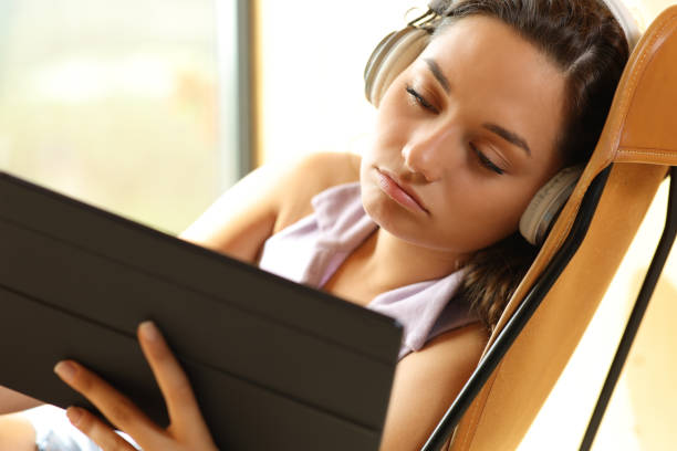 istock Bored woman watching videos on tablet 1436074601